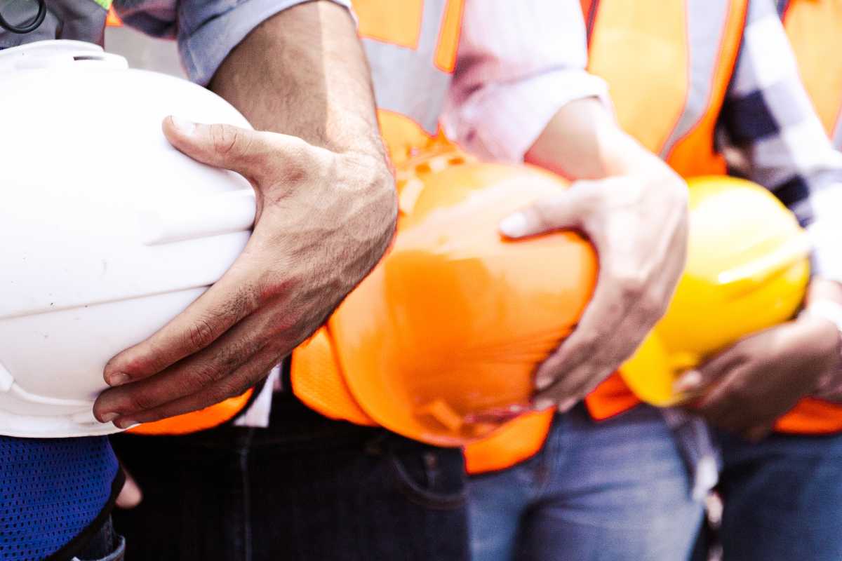 Hands holding hard hats