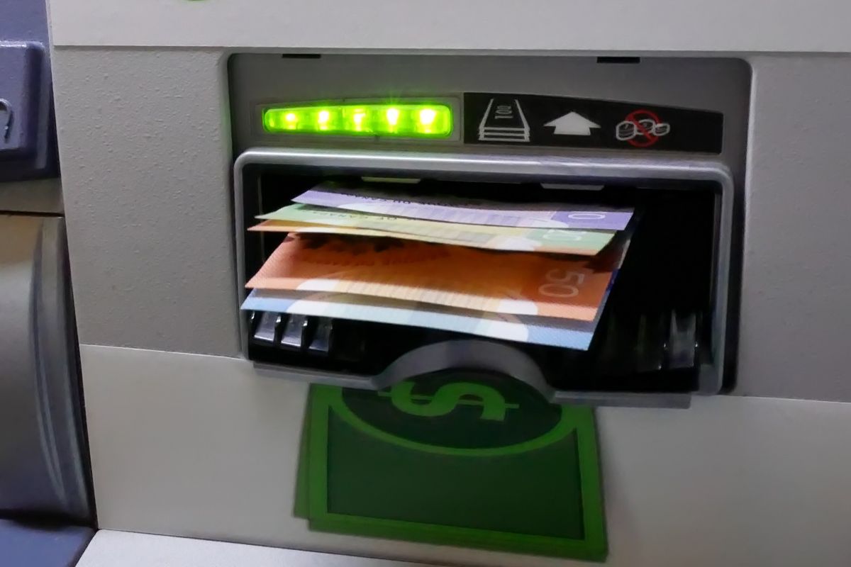 Canadian dollars being withdrawn from an ATM