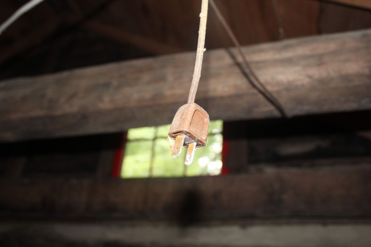 An unplugged cable dangling from a ceiling