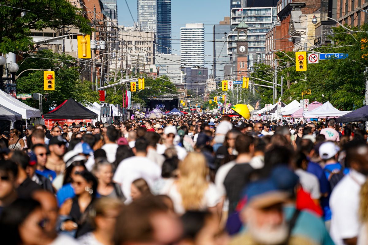 A crowd on a street in downtown Toronto