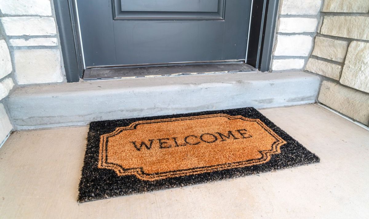 A welcome mat outside a front door