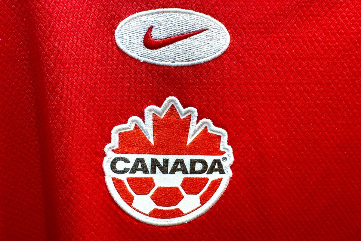 The Nike and Canada Soccer logos on a red jersey