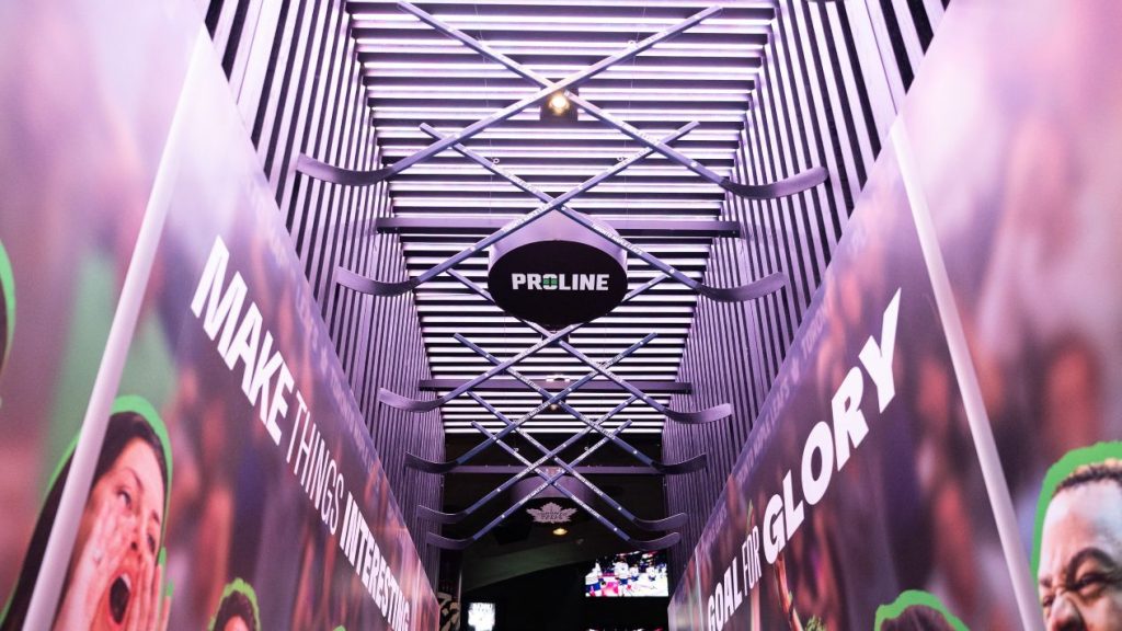 A sign for OLG's PROLINE sportsbook in a neon walkway