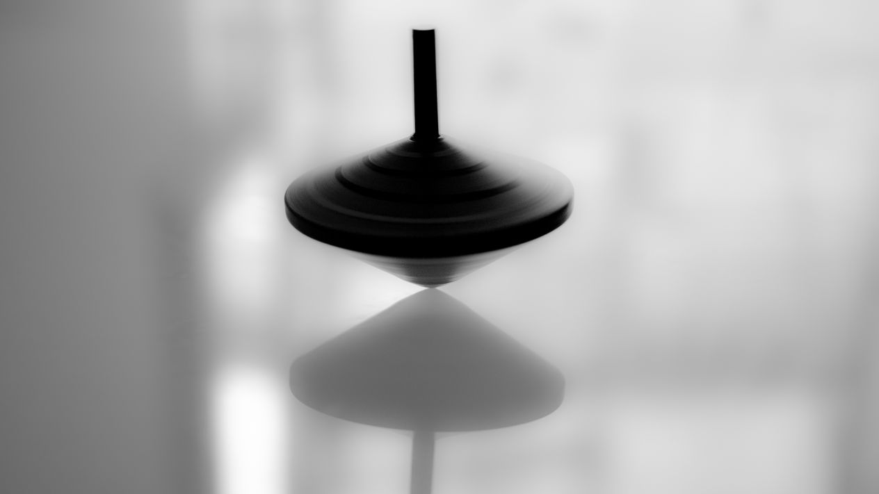 A spinning top spinning on a surface