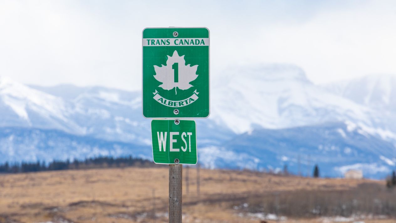 A green maple leaf sign for the Trans Canada Highway, heading West from Calgary, Alberta