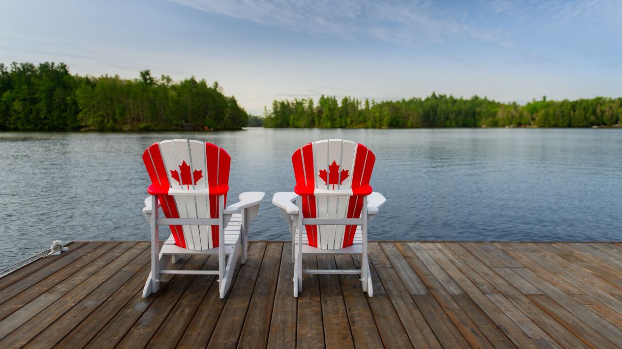 Two Adirondack chairs painted with the Canada flag