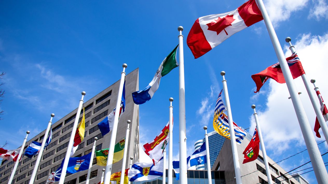 The flag of Canada and the flags of the provinces flying