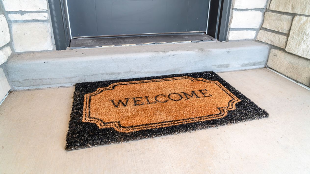 A welcome mat outside a front door
