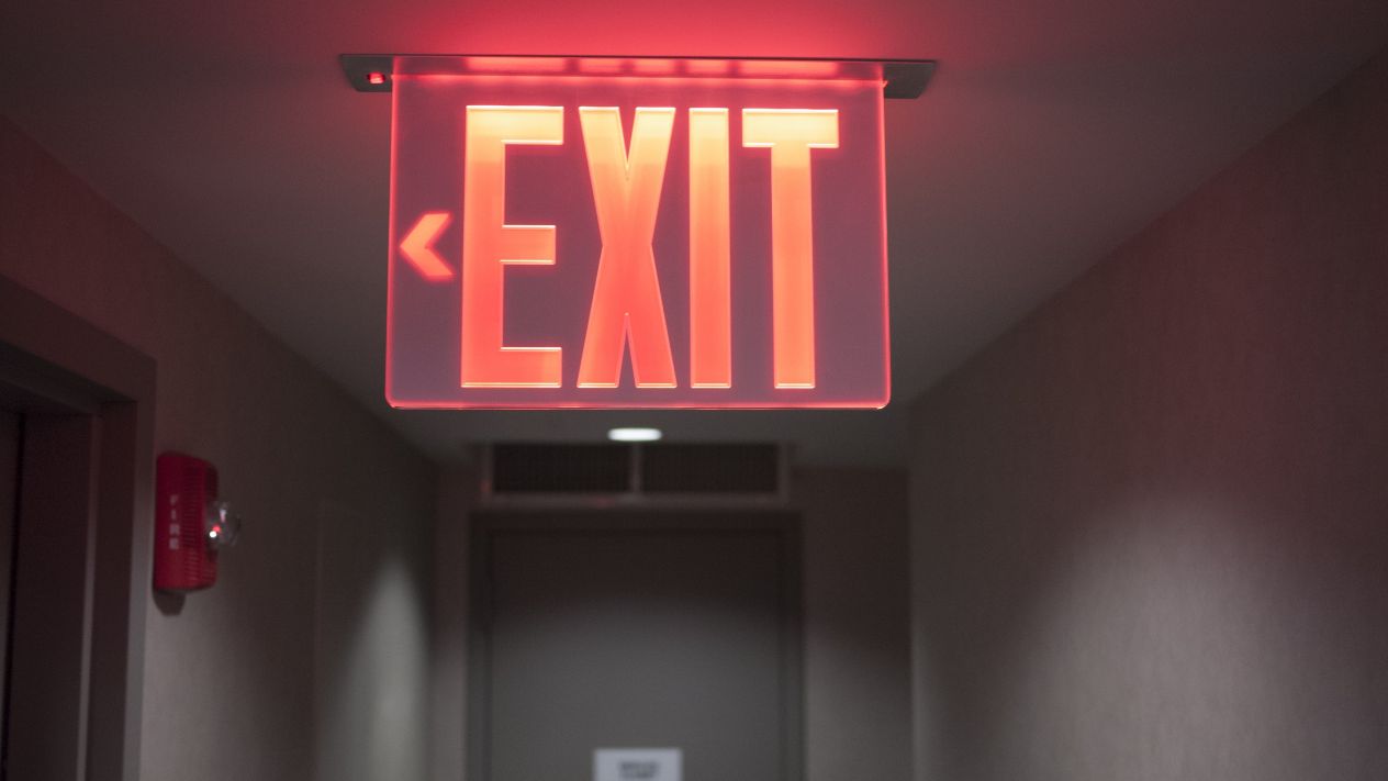 A red neon exit sign