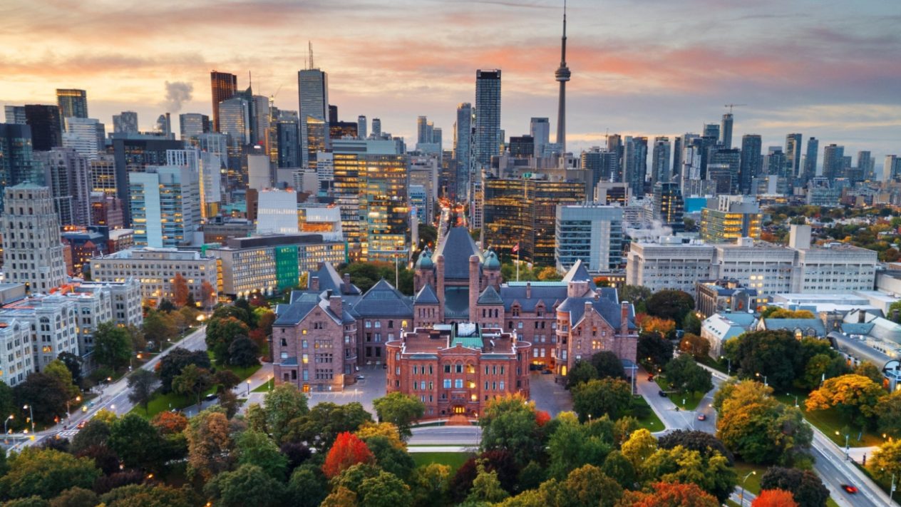 A photo of the Toronto skyline with the Legislative Assembly of Ontario in the foreground
