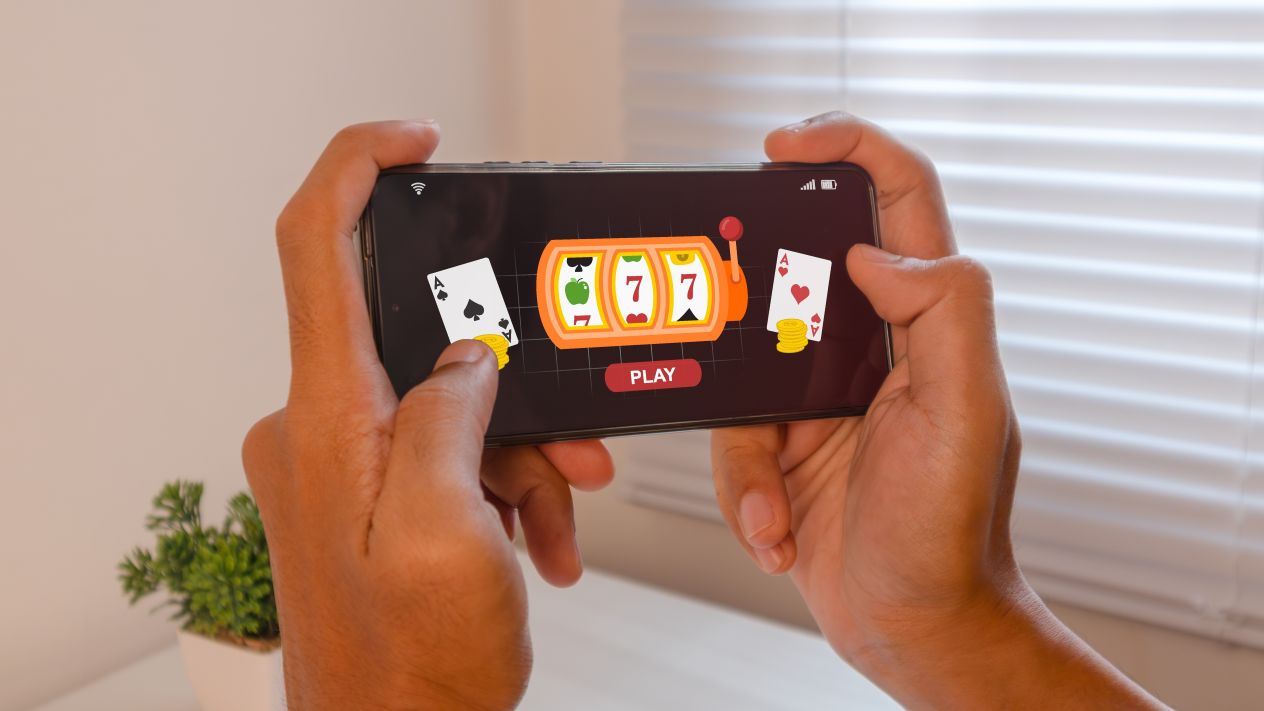 A person playing online casino slots on a phone