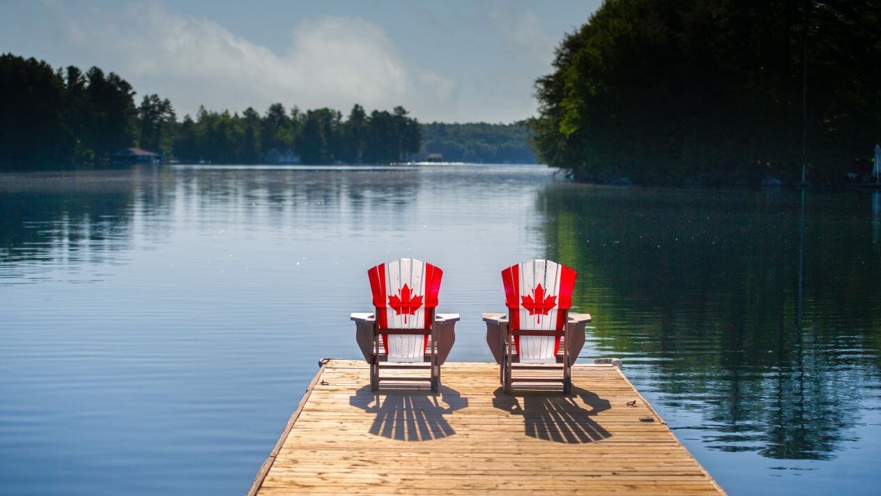 Two Adirondack chairs painted with the Canadian flag